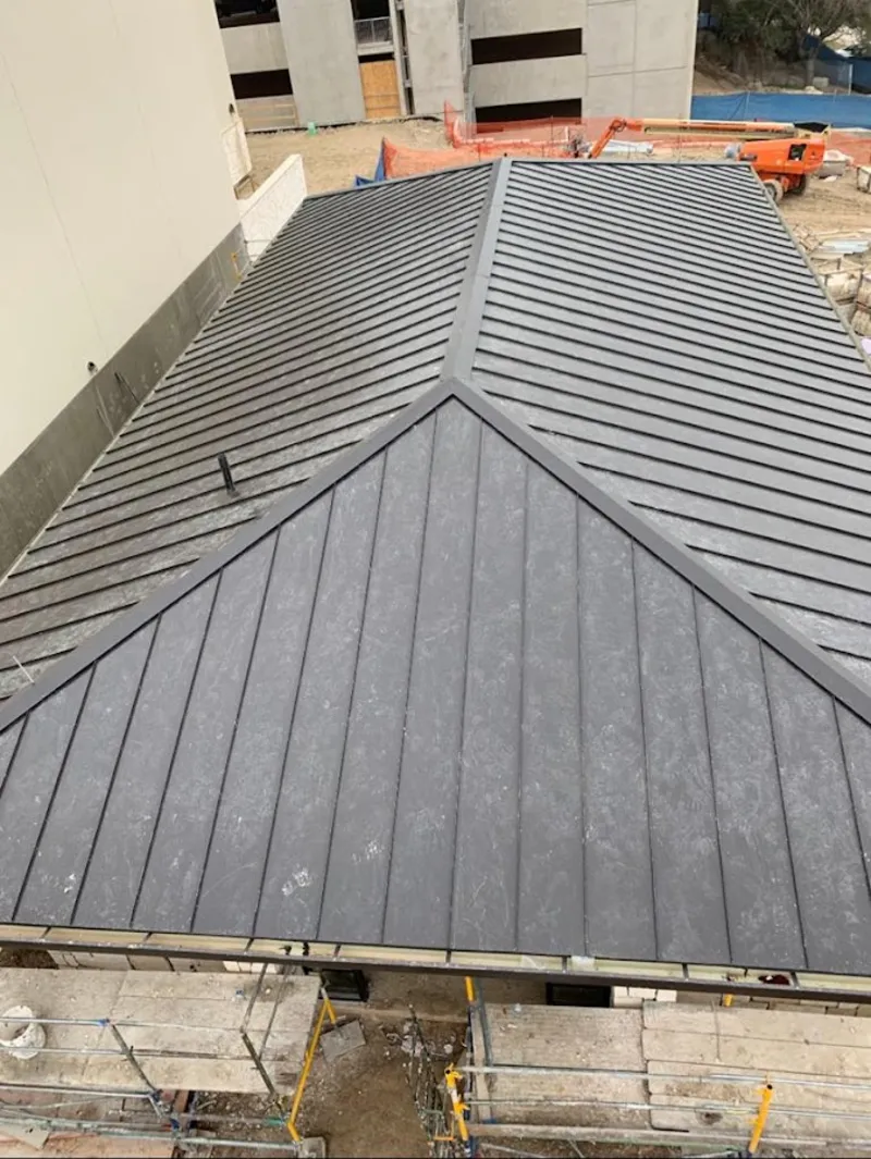 Commercial metal roof construction with crane equipment in Palm Beach