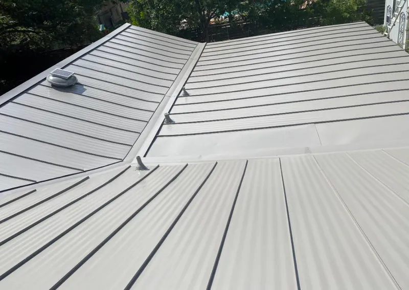 Solar attic fan installed on a metal roof for Roof Ventilation in Palm Beach